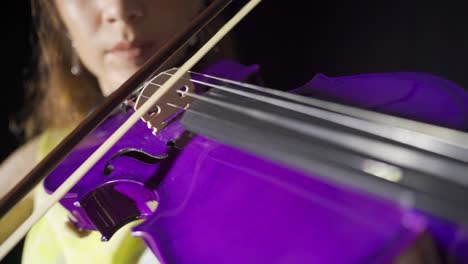 Close-up-of-young-woman-playing-violin-on-stage.-Violinist.